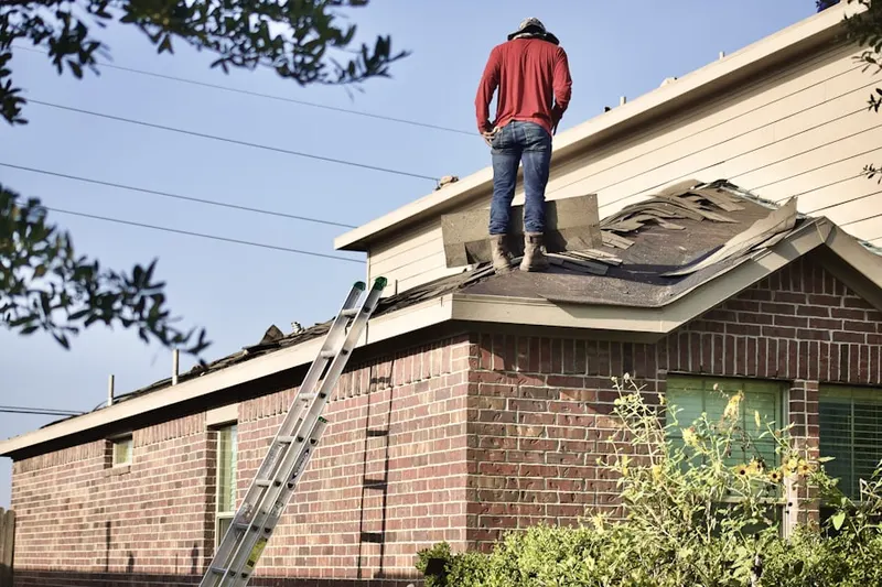 Professional roofer working on a residential roof in Happy Trails